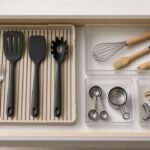 Expandable utensil trays and modular bins inside a tiny rental kitchen drawer