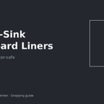 Waterproof under-sink cupboard liner cut to fit around pipes in a rental cabinet