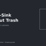 Pull-out trash can sliding from under an apartment kitchen sink around pipes