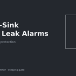 Battery water leak alarm sensor placed under an apartment kitchen sink near the trap